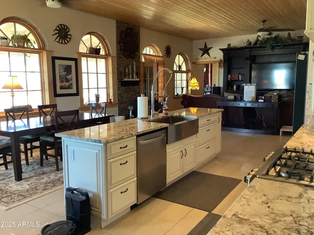 a kitchen with stainless steel appliances granite countertop a refrigerator and a stove