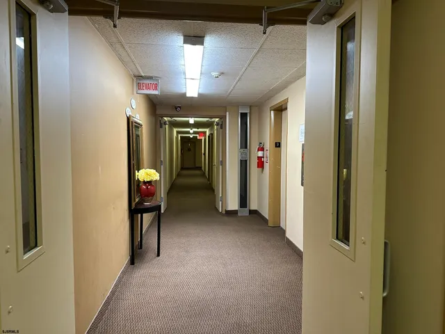 a view of a hallway with wooden shelves
