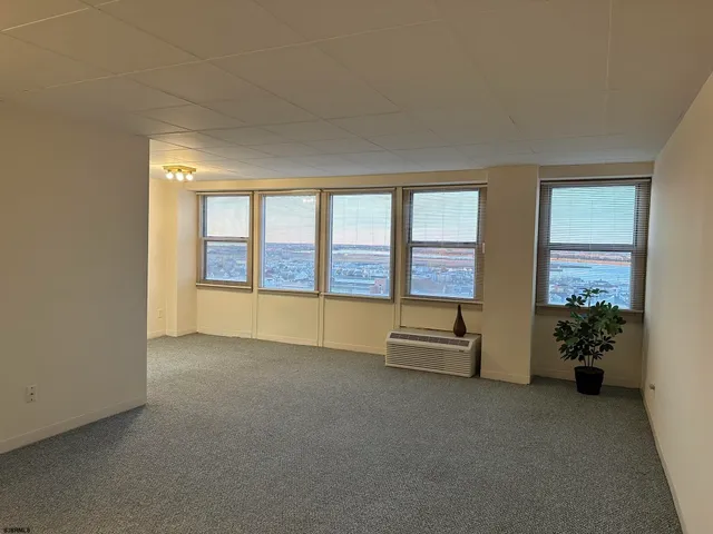 an empty room with furniture and windows