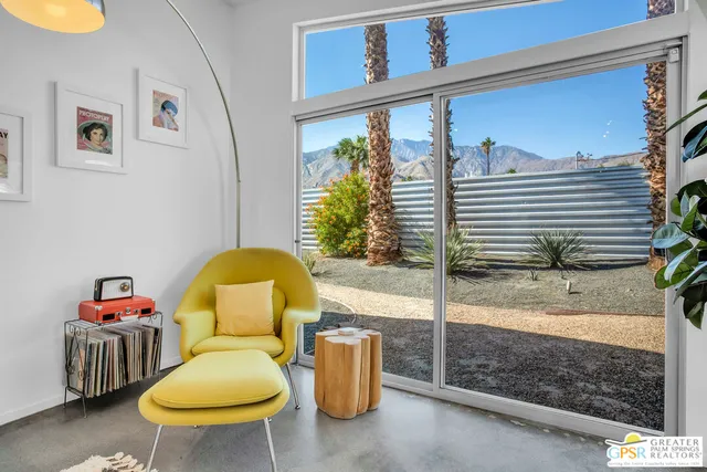 a kitchen with stainless steel appliances kitchen island granite countertop a stove a sink a refrigerator and white cabinets