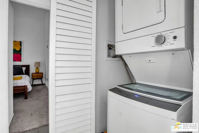 a kitchen with stainless steel appliances granite countertop a sink and a refrigerator