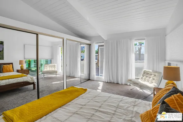 a bedroom with a bed and wall painting