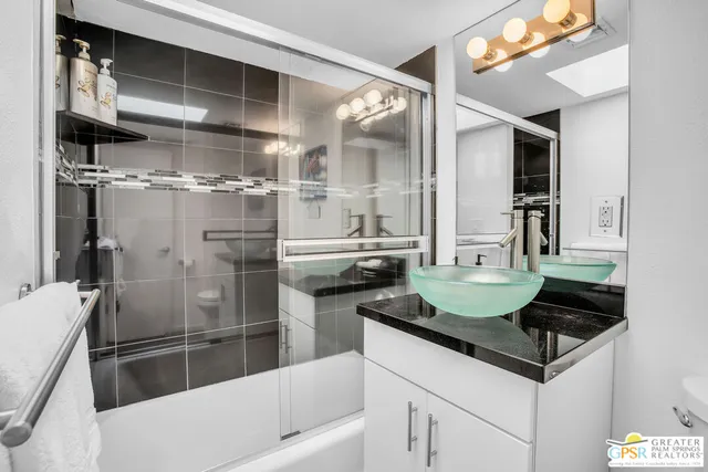 a bedroom with a bed a lamp and a window