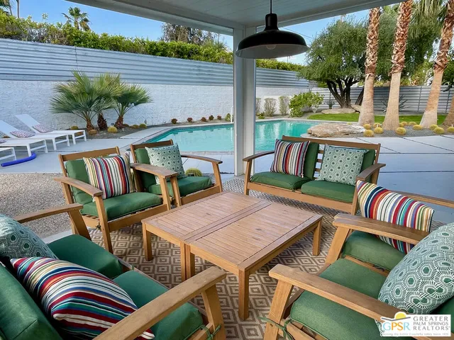 a view of a backyard with sitting area