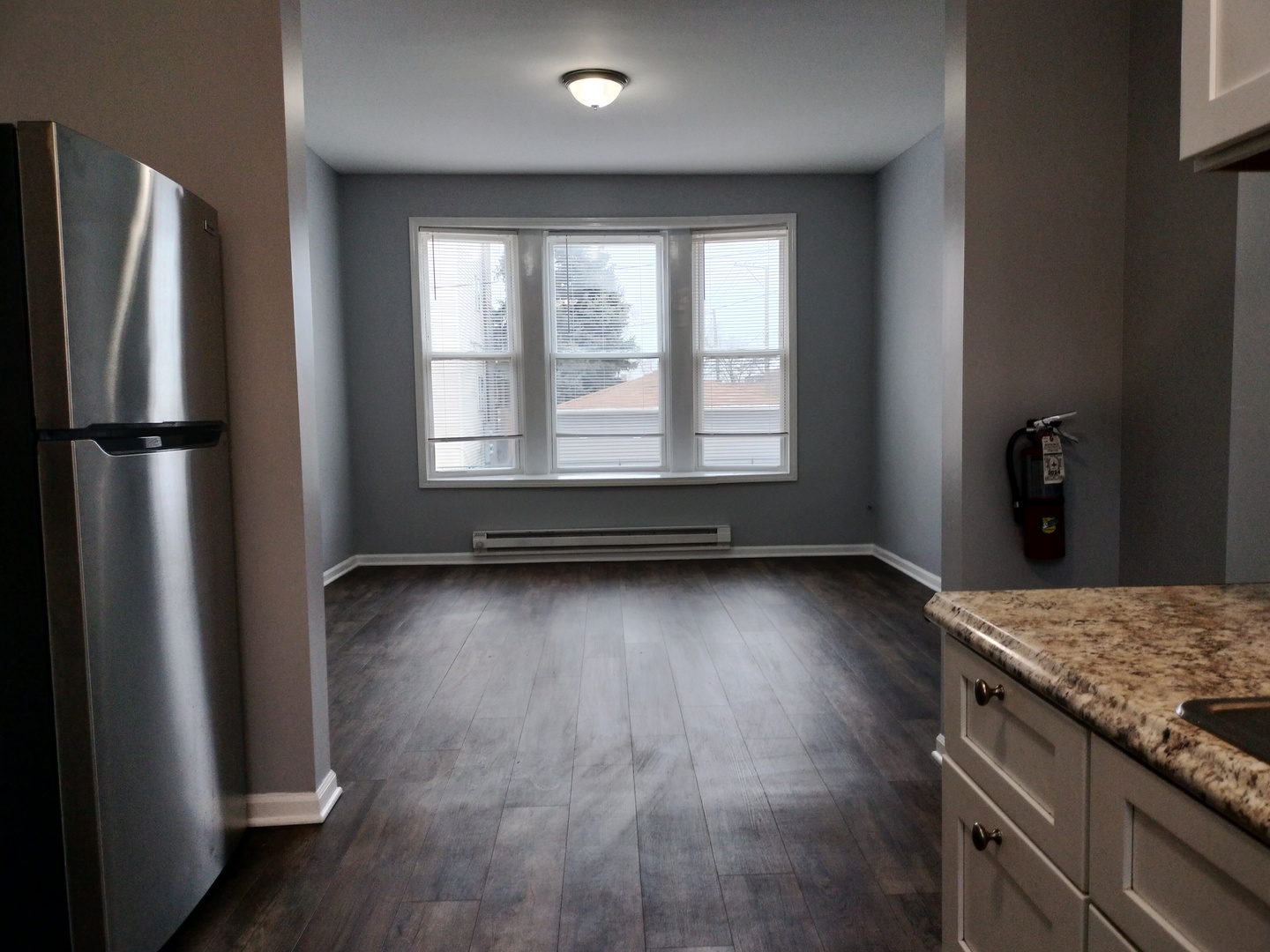 6601 South Green Street, Unit 8171 Chicago, IL 60621 - Photo 11 of 28 a view of kitchen with refrigerator and wooden floor