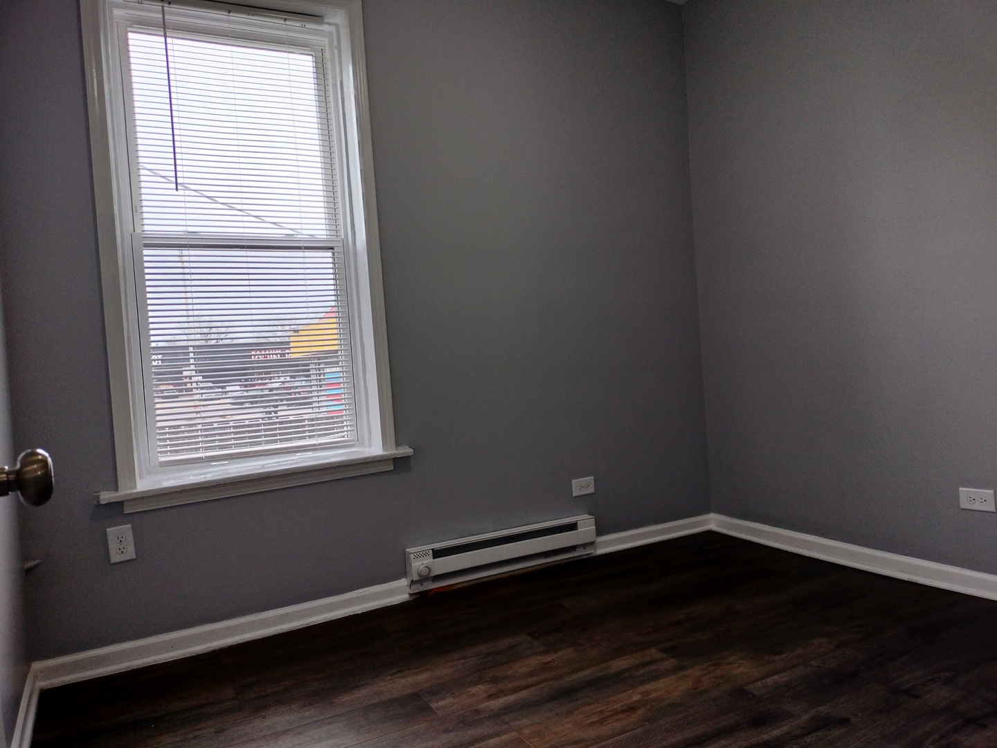 6601 South Green Street, Unit 8171 Chicago, IL 60621 - Photo 19 of 28 a room with wooden floor and windows