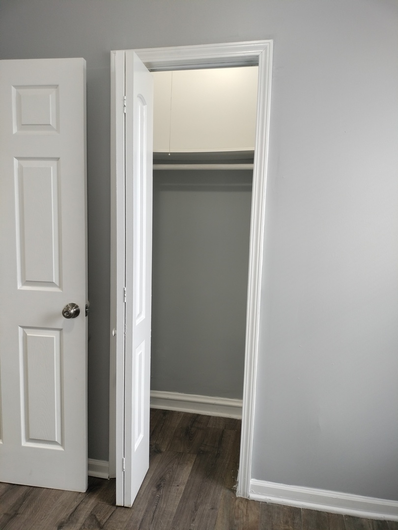 6601 South Green Street, Unit 8171 Chicago, IL 60621 - Photo 22 of 28 a view of a hallway with wooden floor