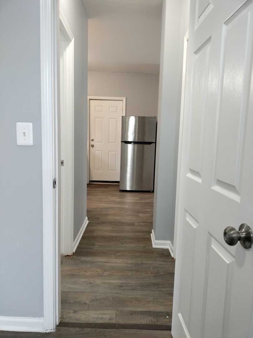 6601 South Green Street, Unit 8171 Chicago, IL 60621 - Photo 23 of 28 a view of a hallway with wooden floor