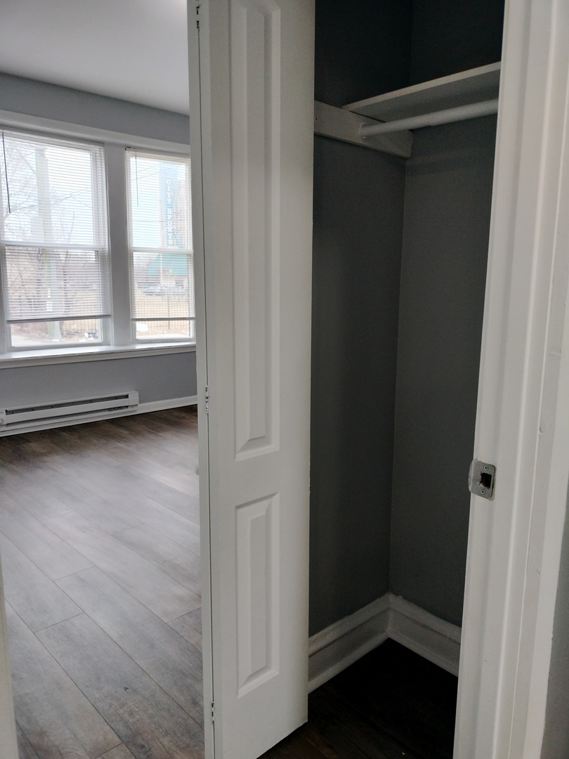 6601 South Green Street, Unit 8171 Chicago, IL 60621 - Photo 24 of 28 a view of room with window and hardwood floor