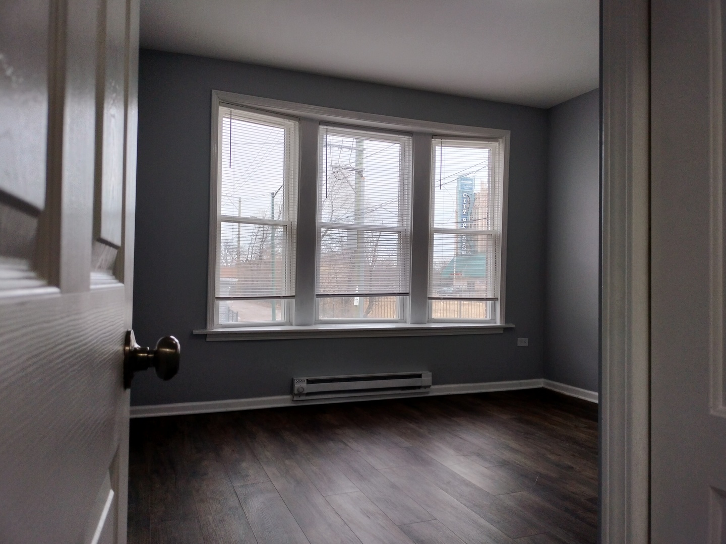 6601 South Green Street, Unit 8171 Chicago, IL 60621 - Photo 26 of 28 a view of room with wooden floor and windows