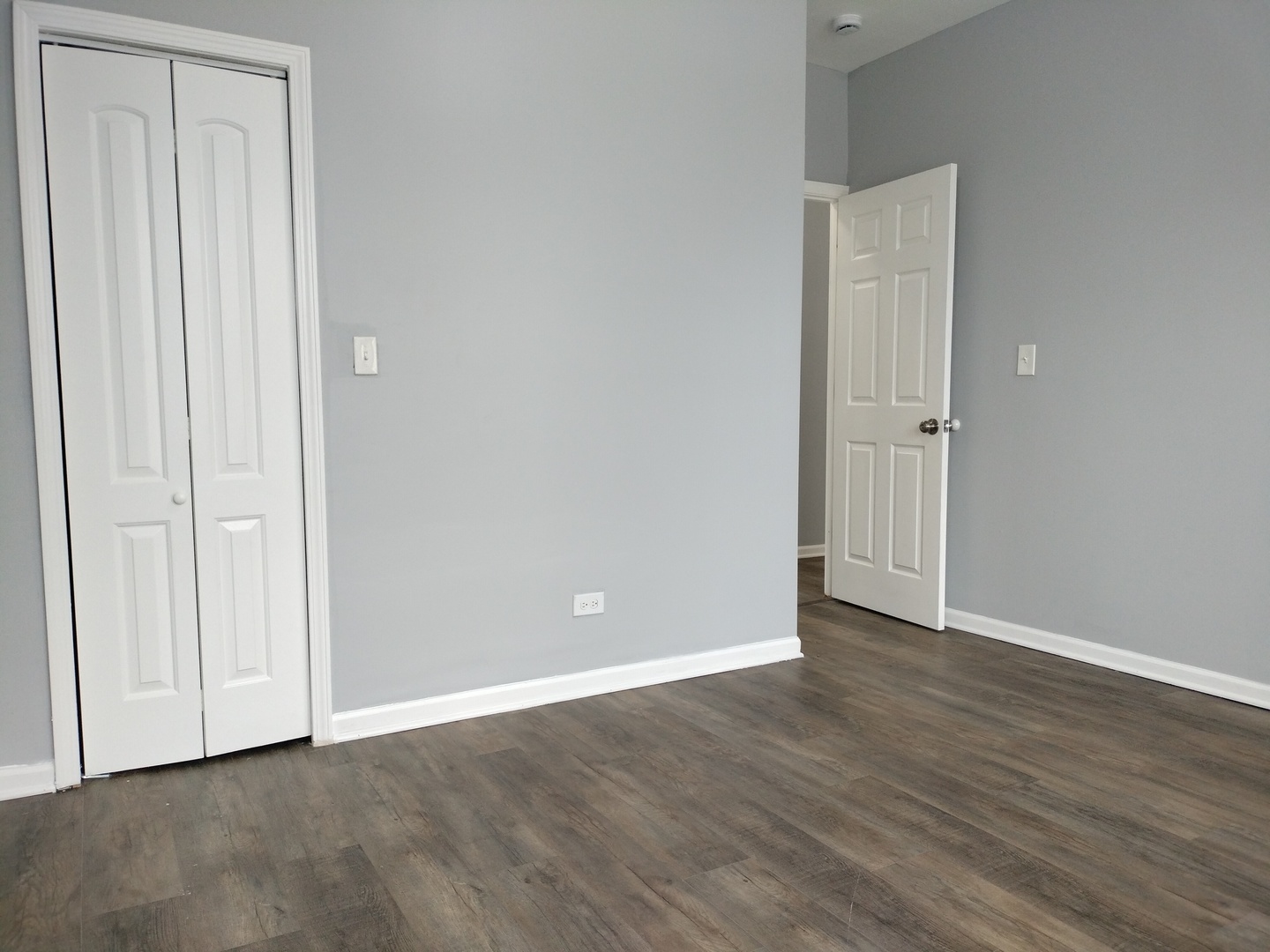 6601 South Green Street, Unit 8171 Chicago, IL 60621 - Photo 27 of 28 a view of an empty room with wooden floor
