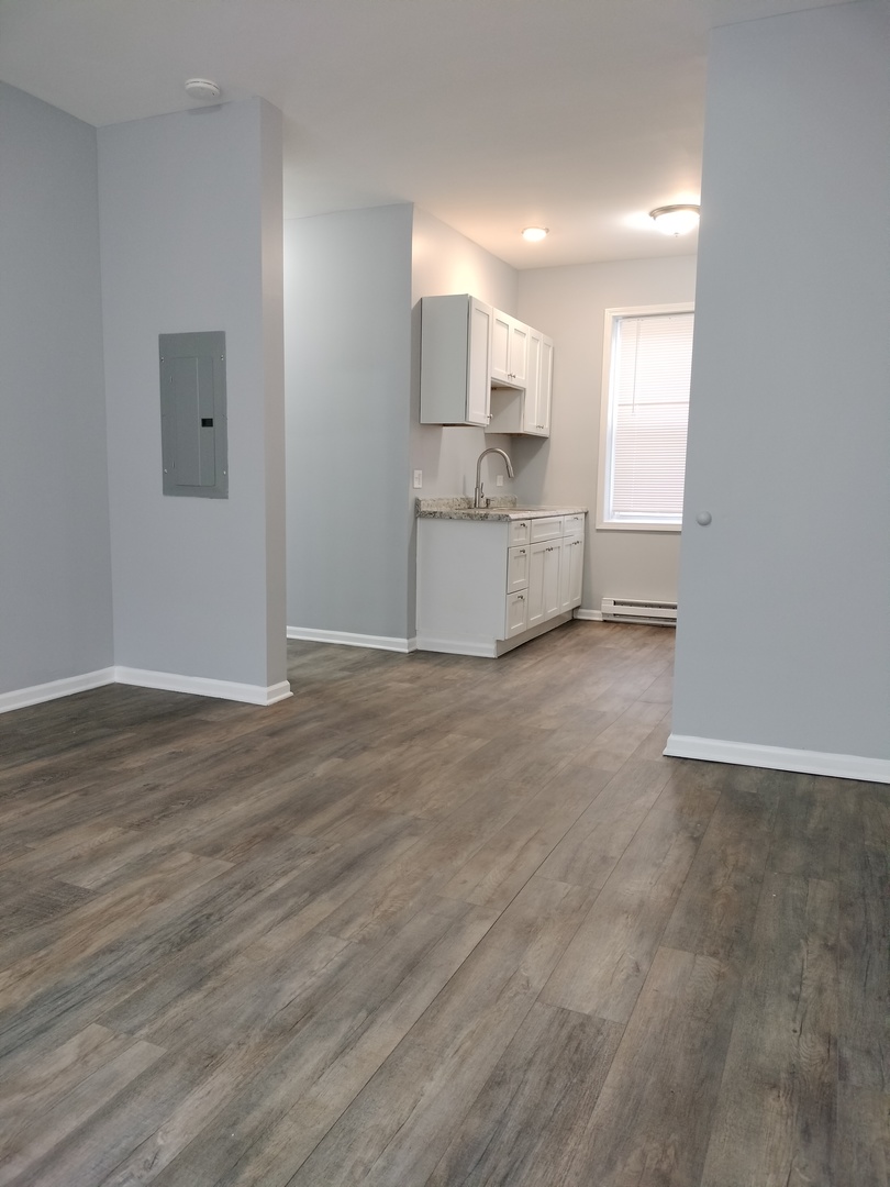 6601 South Green Street, Unit 8171 Chicago, IL 60621 - Photo 3 of 28 a view of a kitchen with a sink and a refrigerator