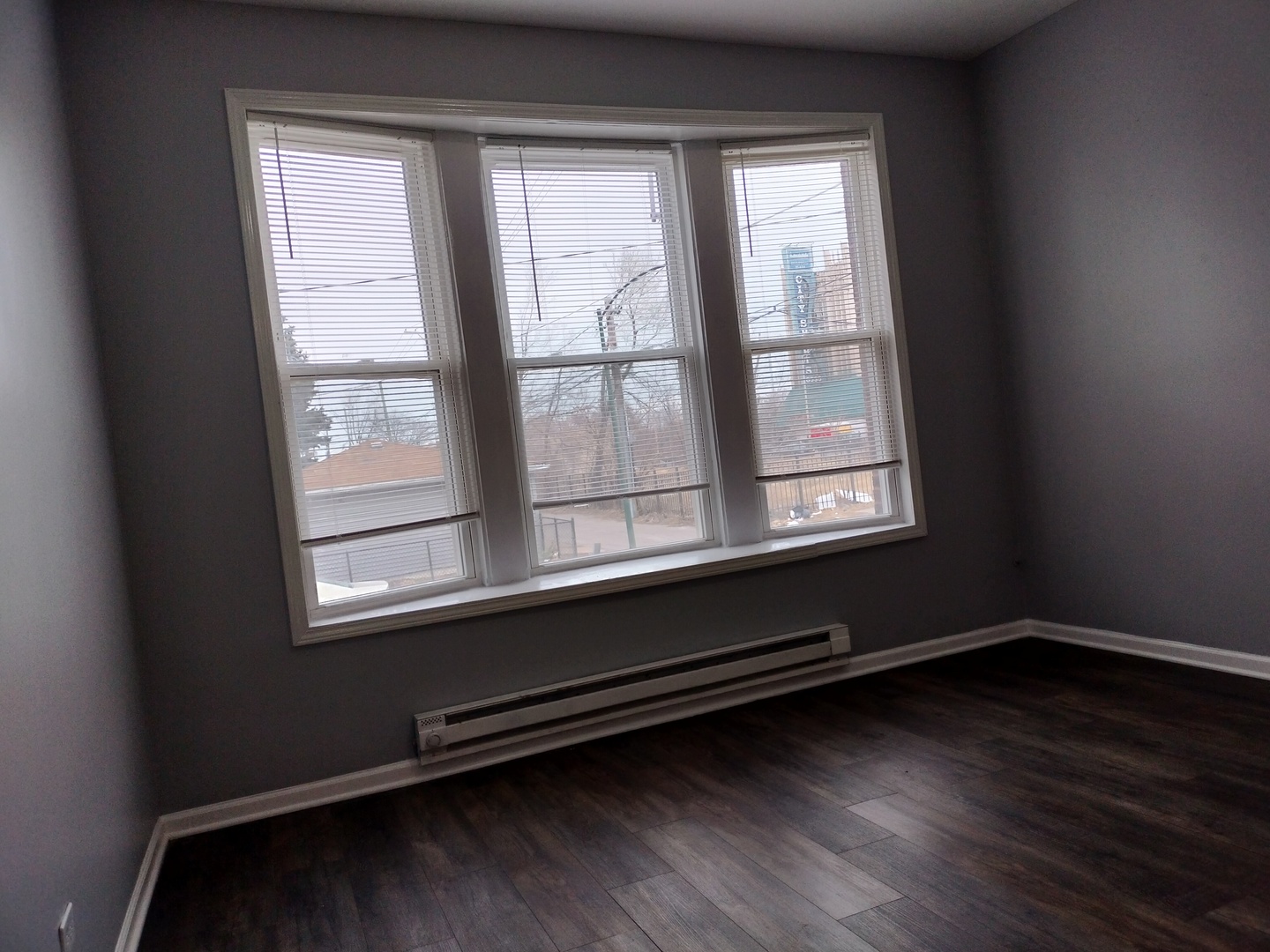 6601 South Green Street, Unit 8171 Chicago, IL 60621 - Photo 4 of 28 a room with wooden floor and a window