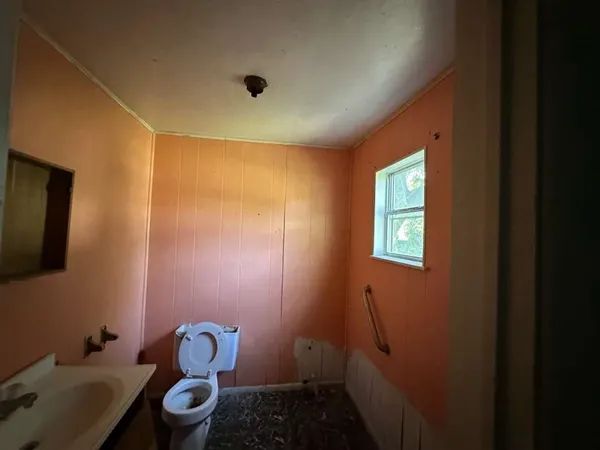 a bathroom with a sink mirror and toilet