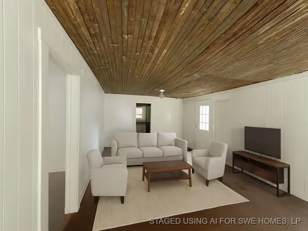 a living room with furniture a rug and a ceiling fan