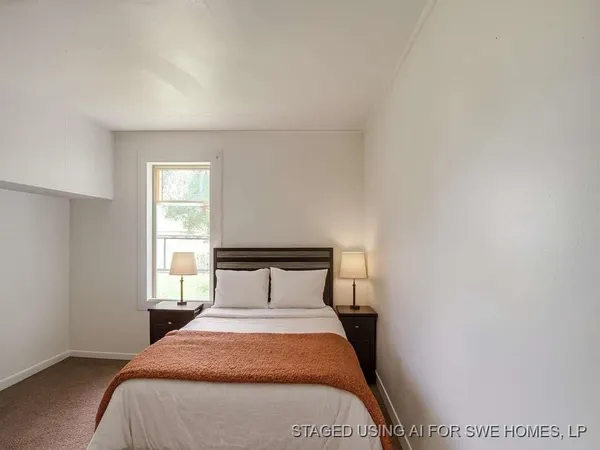 a bedroom with a bed and window