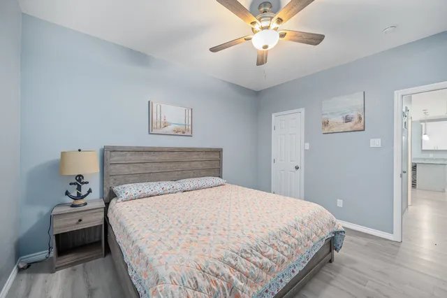 a bedroom with a bed and a chandelier