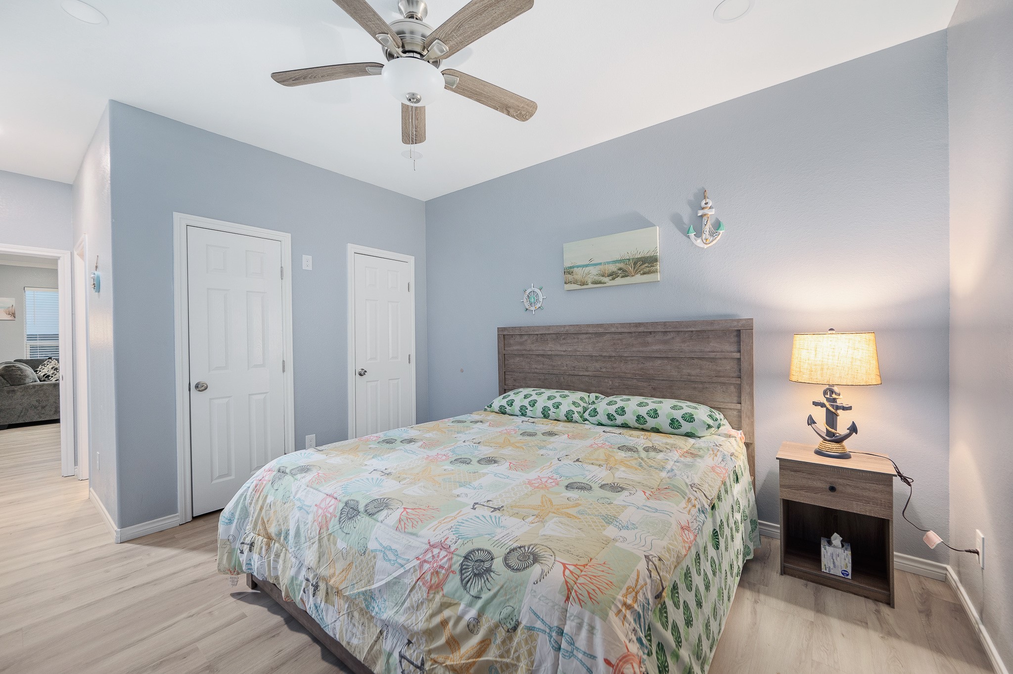 305 Jettyview Road, Unit A Surfside Beach, TX 77541 - Photo 12 of 41 a bedroom with a bed and a chandelier