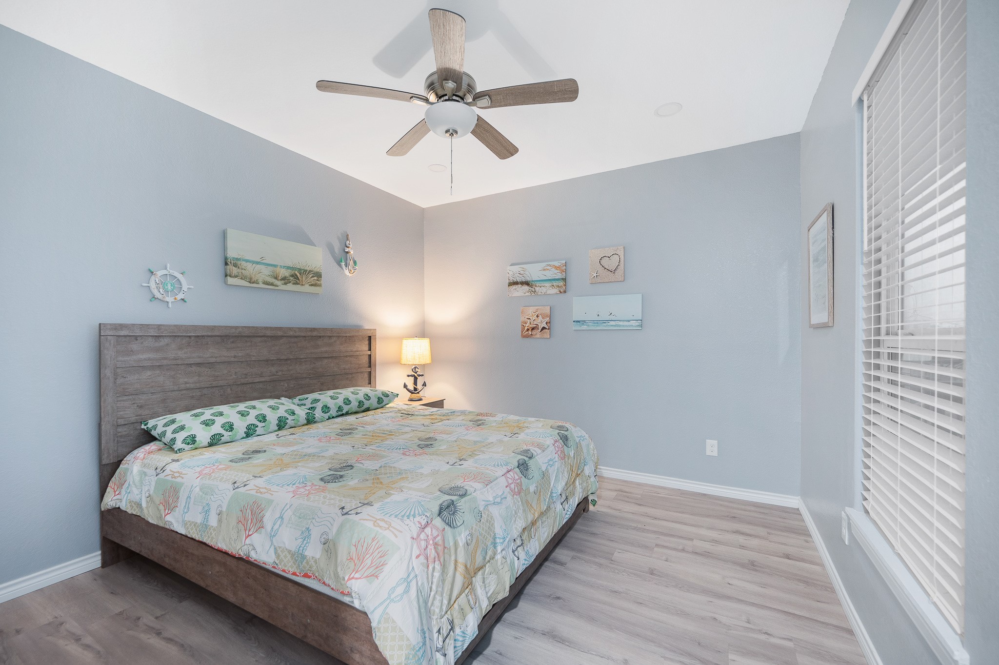 305 Jettyview Road, Unit A Surfside Beach, TX 77541 - Photo 14 of 41 a bedroom with a bed and a chandelier