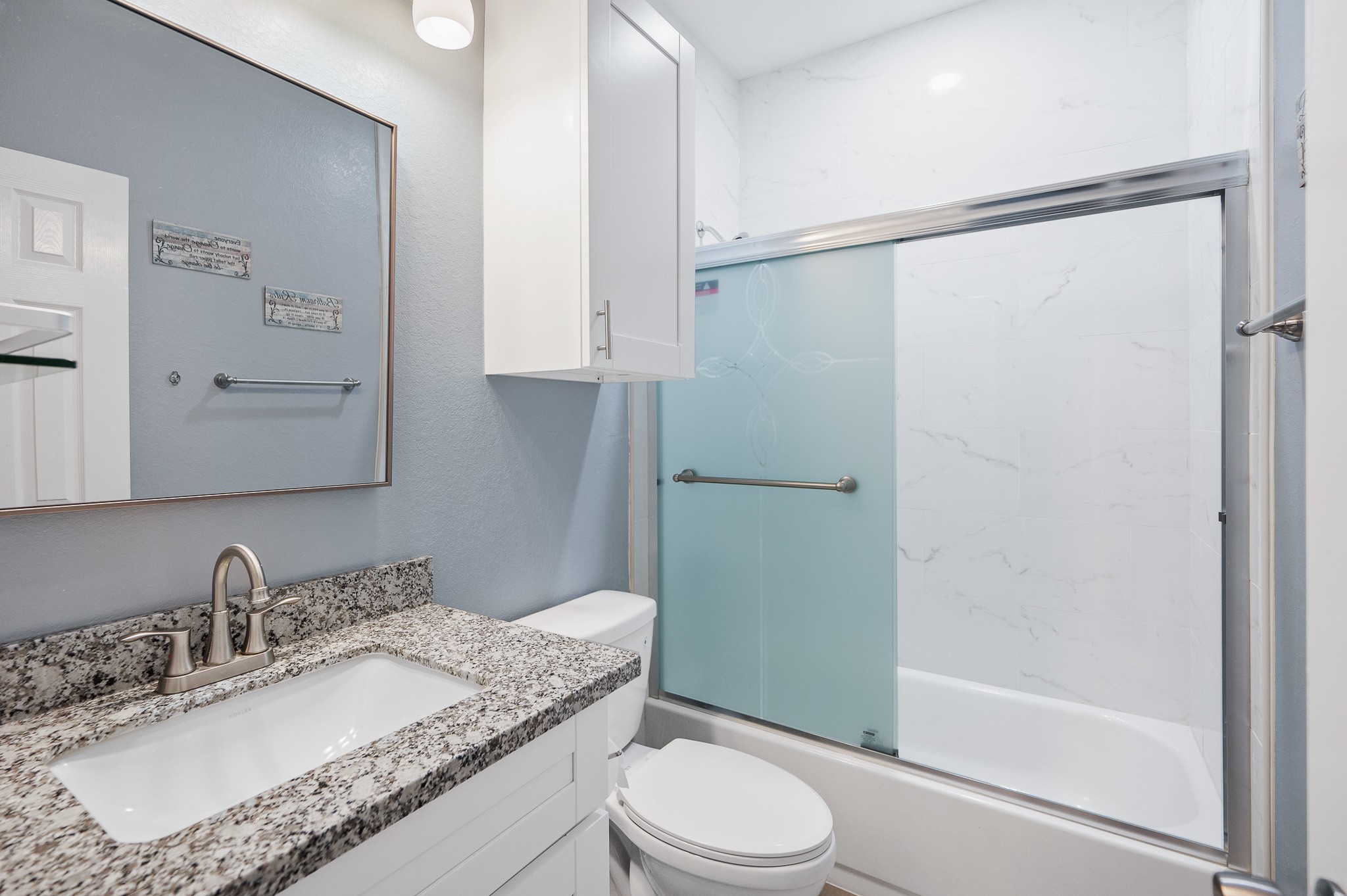 305 Jettyview Road, Unit A Surfside Beach, TX 77541 - Photo 17 of 41 a bathroom with a granite countertop sink toilet and shower