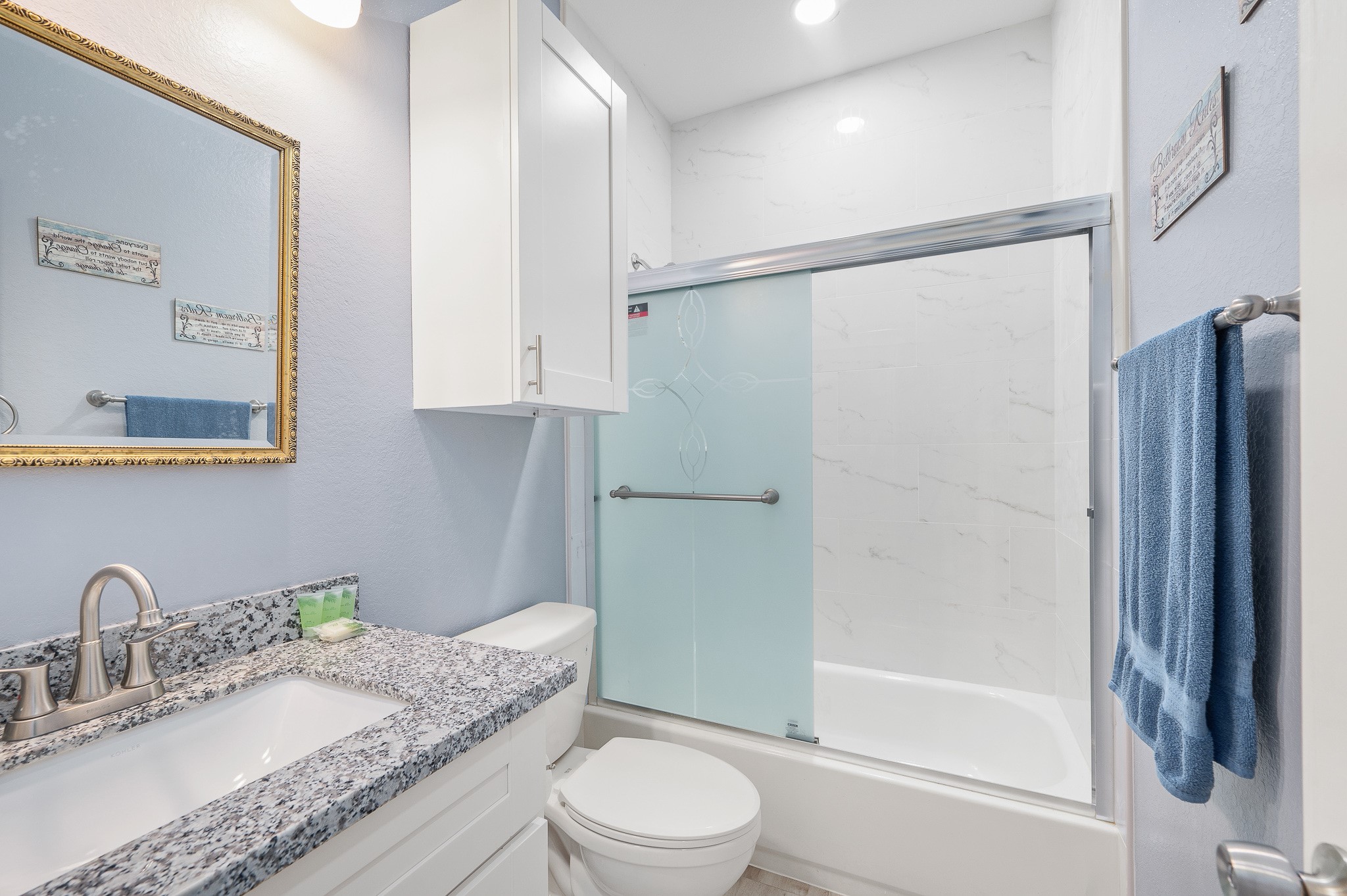 305 Jettyview Road, Unit A Surfside Beach, TX 77541 - Photo 18 of 41 a bathroom with a granite countertop sink toilet and shower
