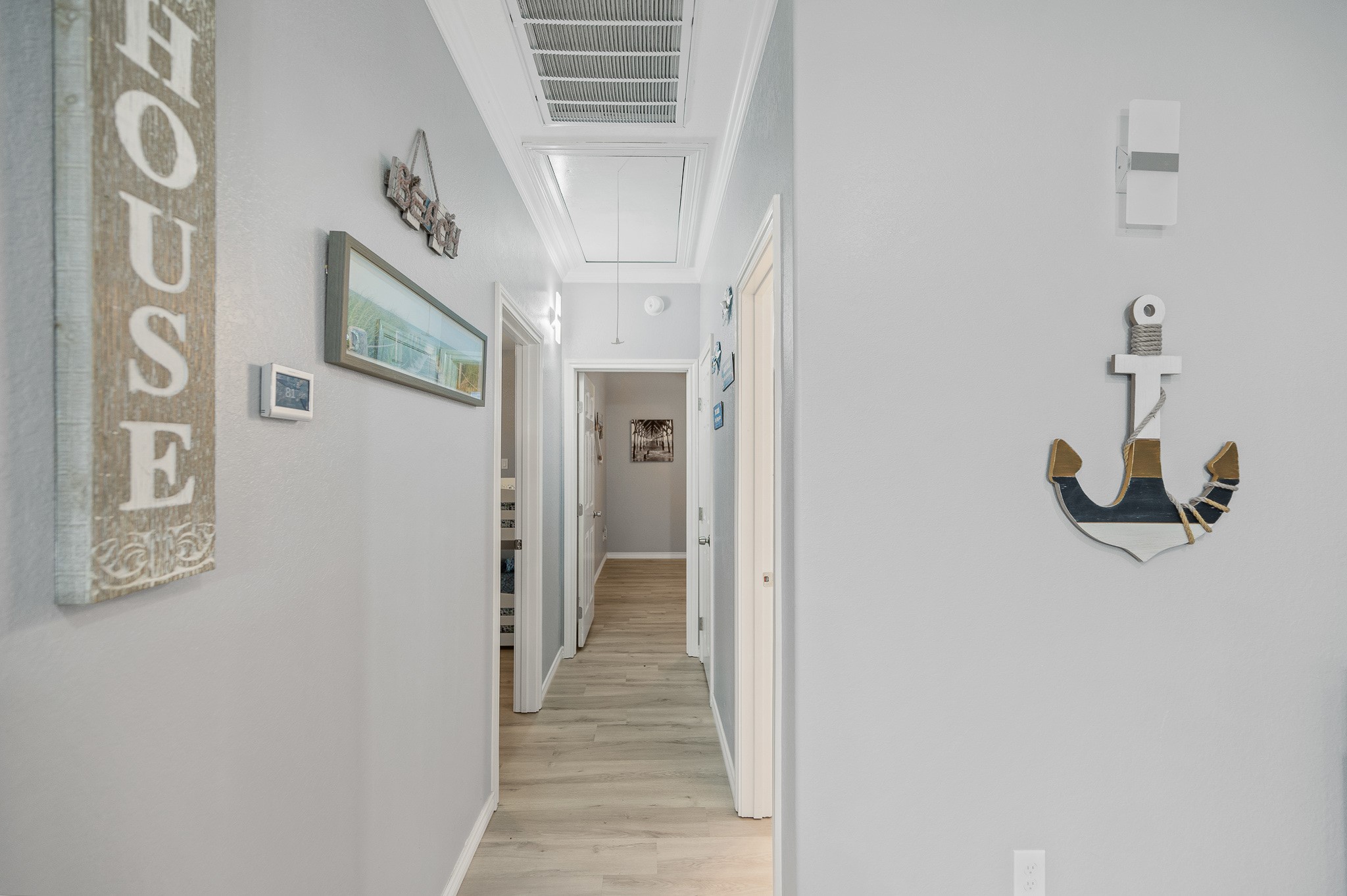 305 Jettyview Road, Unit A Surfside Beach, TX 77541 - Photo 19 of 41 a view of a hallway with wooden floor and entryway