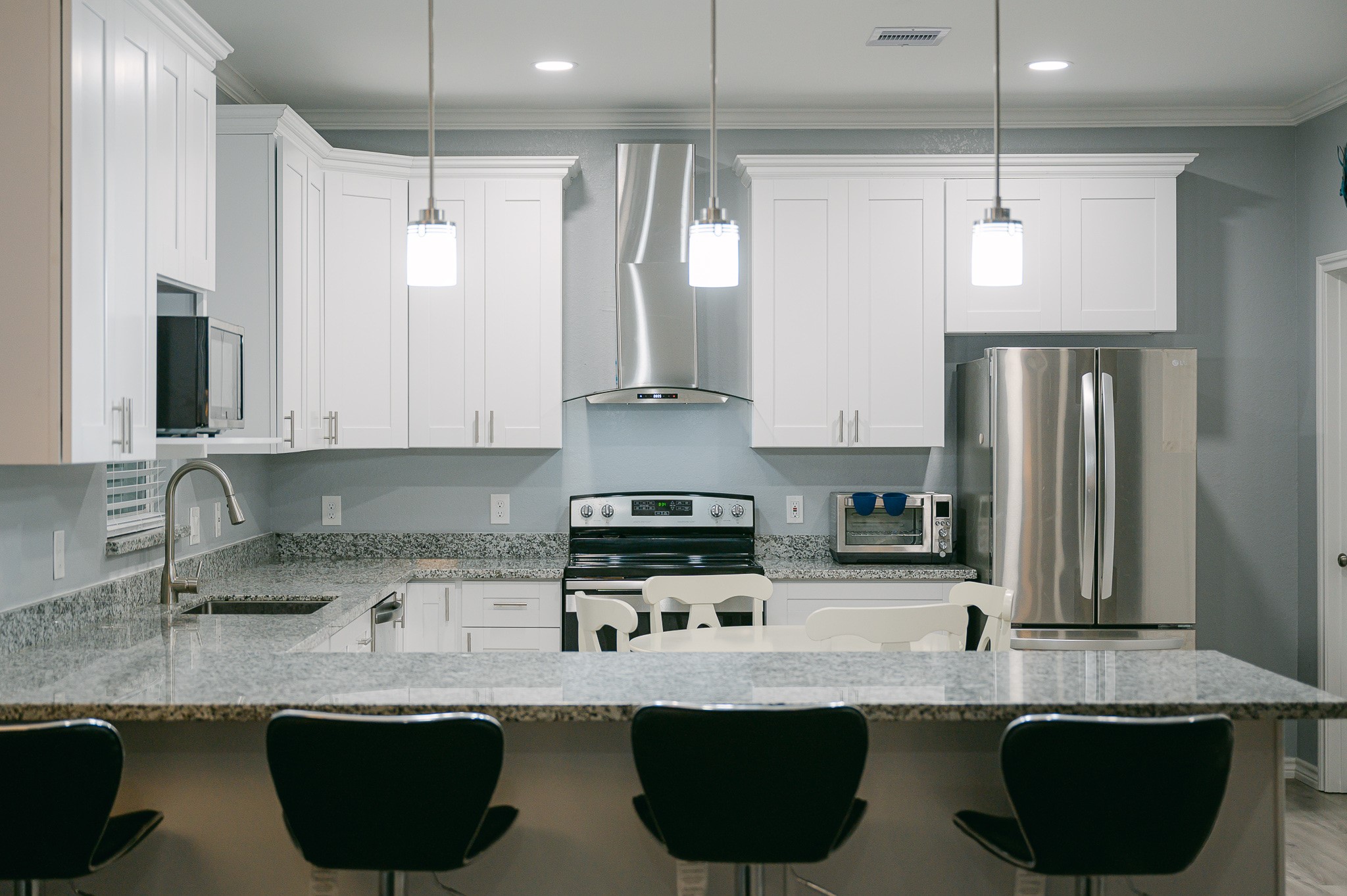 305 Jettyview Road, Unit A Surfside Beach, TX 77541 - Photo 20 of 41 a kitchen with stainless steel appliances granite countertop a sink a stove and a refrigerator