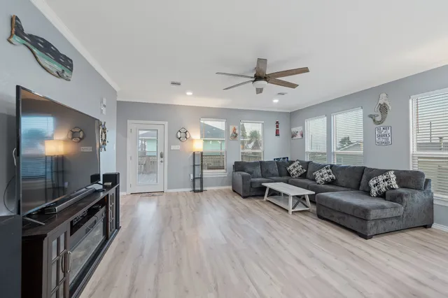 a living room with furniture and a flat screen tv