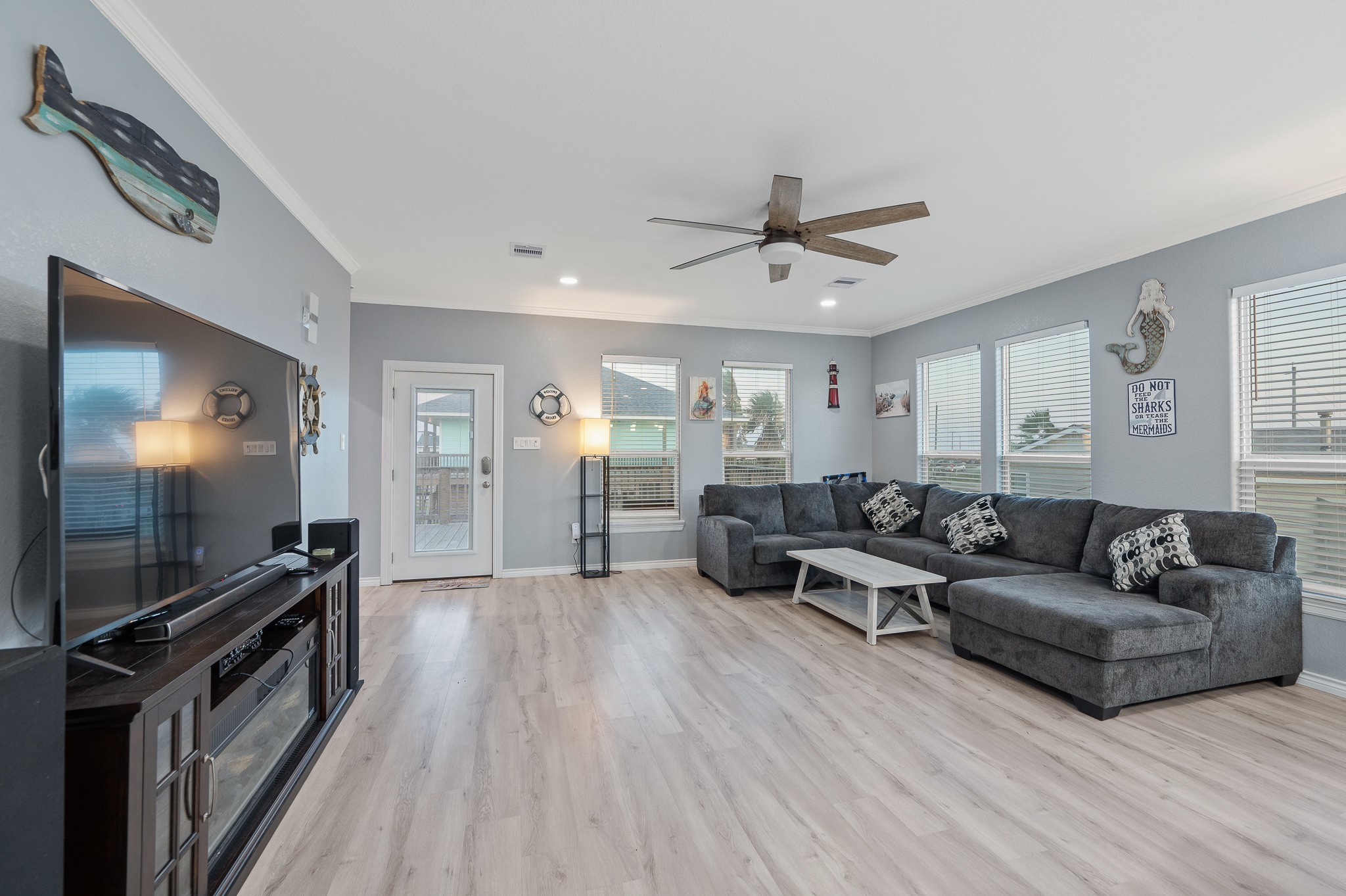 305 Jettyview Road, Unit A Surfside Beach, TX 77541 - Photo 3 of 41 a living room with furniture and a flat screen tv