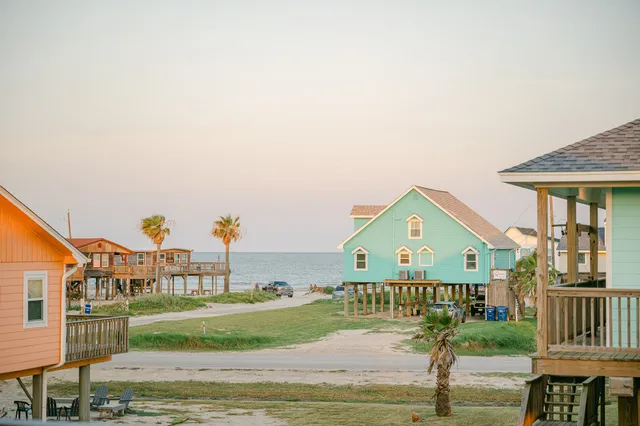 a kitchen with a dining table chairs and white cabinets