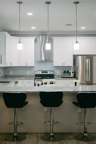 a kitchen with a sink cabinets and wooden floor