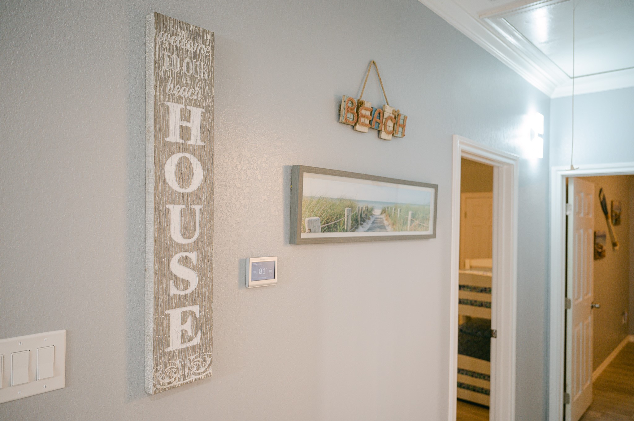 305 Jettyview Road, Unit A Surfside Beach, TX 77541 - Photo 34 of 41 a view of a hallway with paintings on the wall