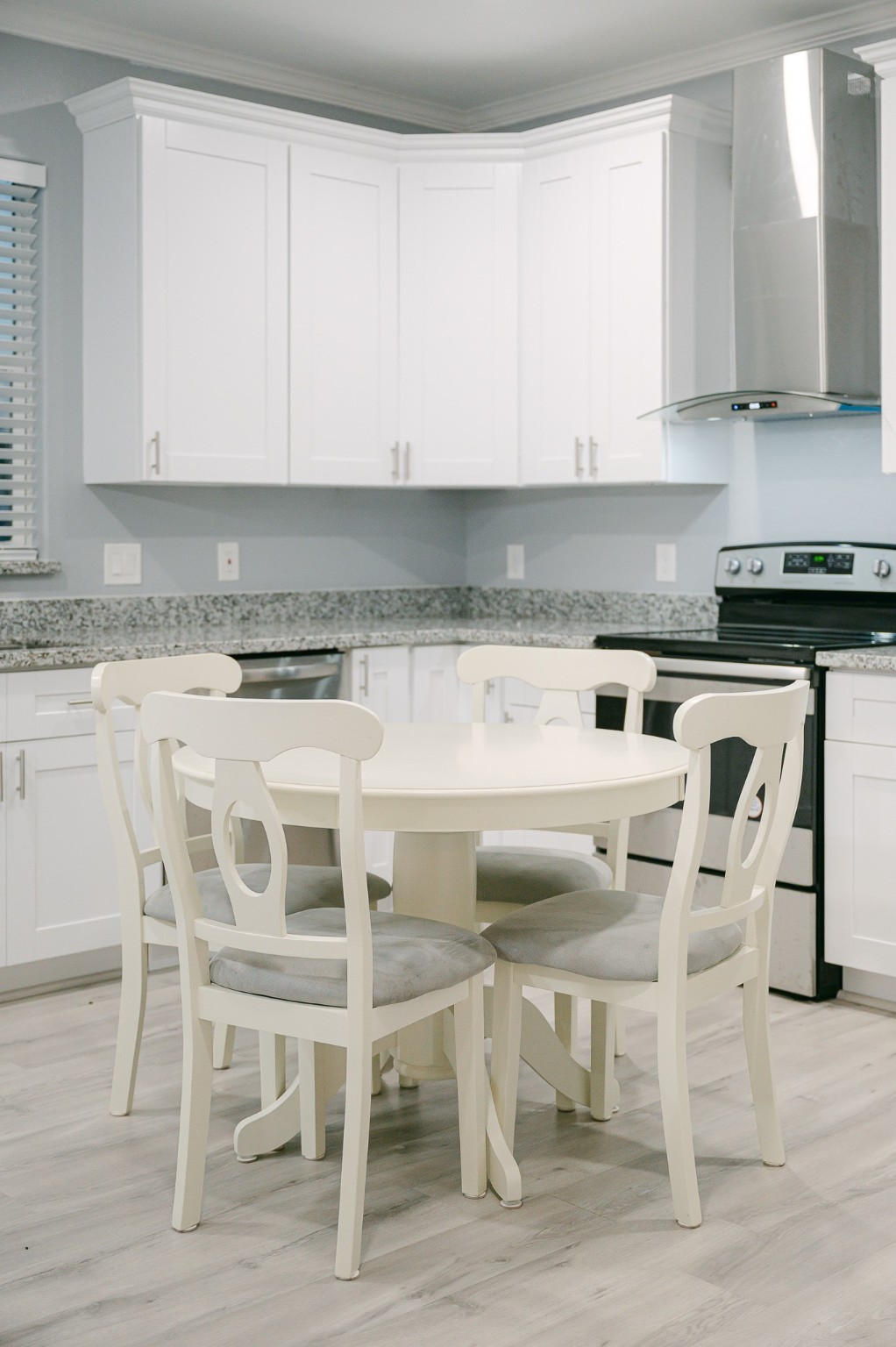 305 Jettyview Road, Unit A Surfside Beach, TX 77541 - Photo 35 of 41 a kitchen with a dining table chairs and white cabinets