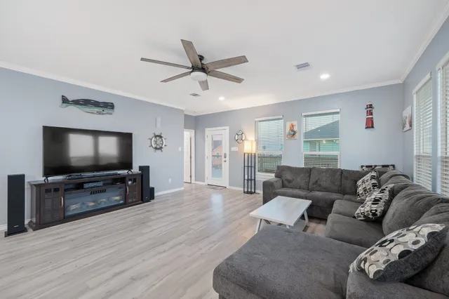 a living room with furniture and a flat screen tv