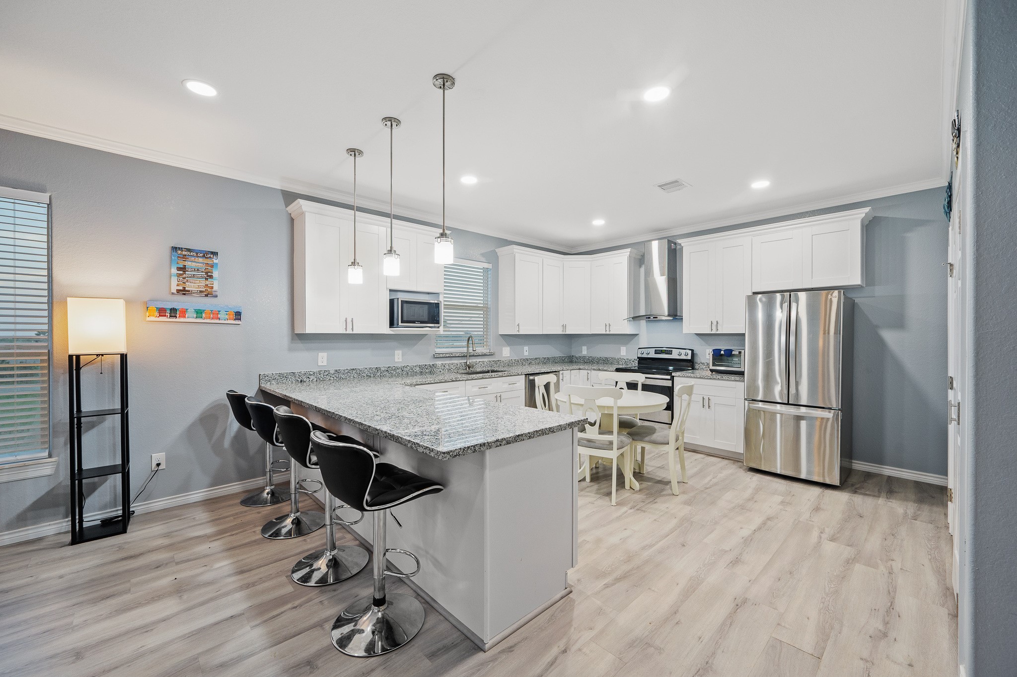 305 Jettyview Road, Unit A Surfside Beach, TX 77541 - Photo 7 of 41 a kitchen with a table chairs refrigerator and microwave