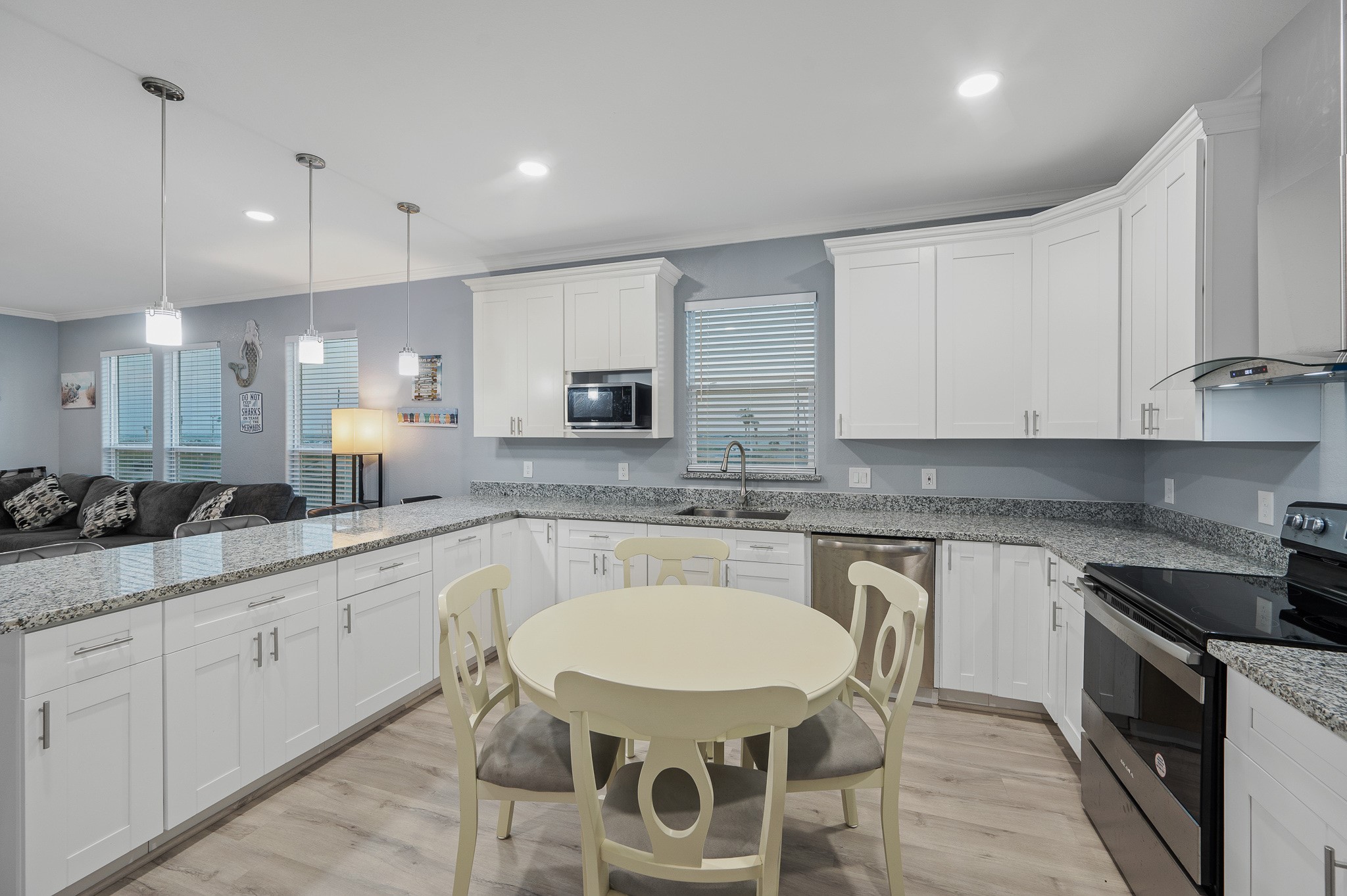 305 Jettyview Road, Unit A Surfside Beach, TX 77541 - Photo 10 of 41 a kitchen with white cabinets stove and sink