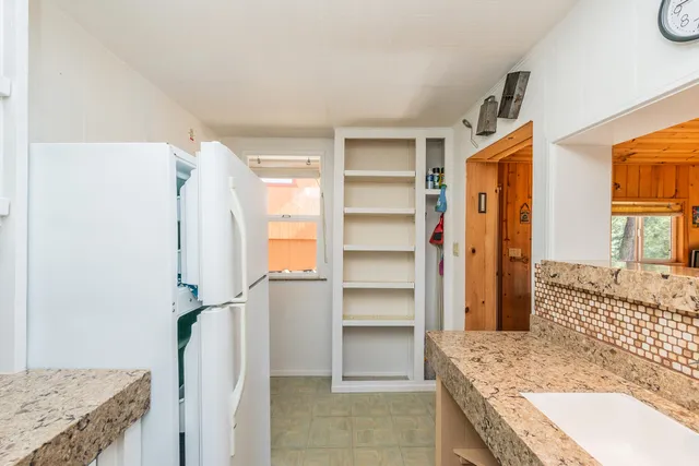 a view of a house with backyard porch and sitting area