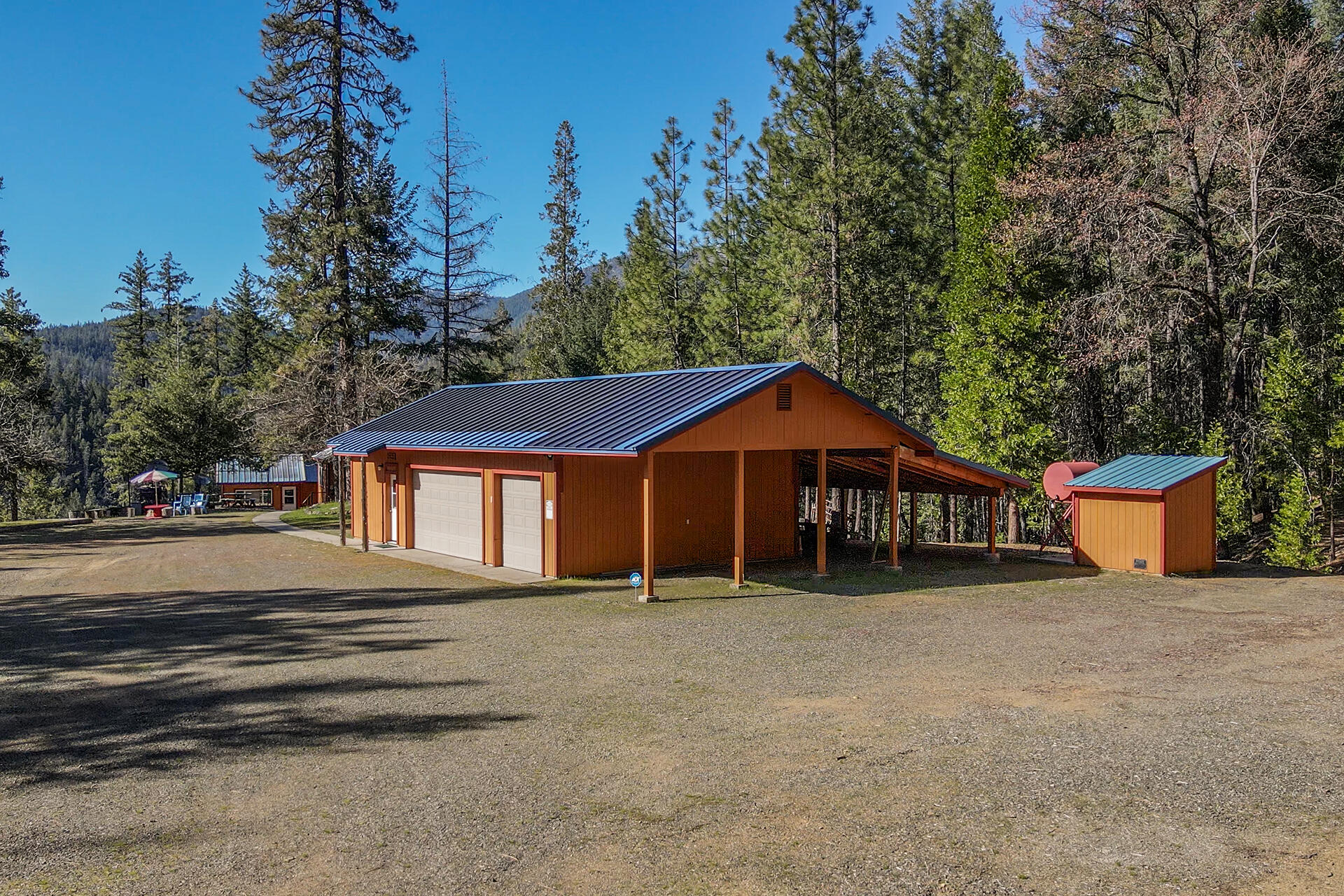 8341 East Side Road Trinity Center, CA 96091 - Photo 2 of 79 a front view of a house with a garden
