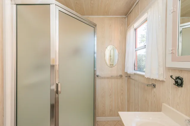 a view of a house with yard and trees