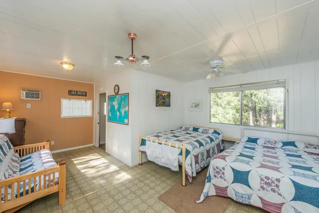 a view of an house with backyard and trees