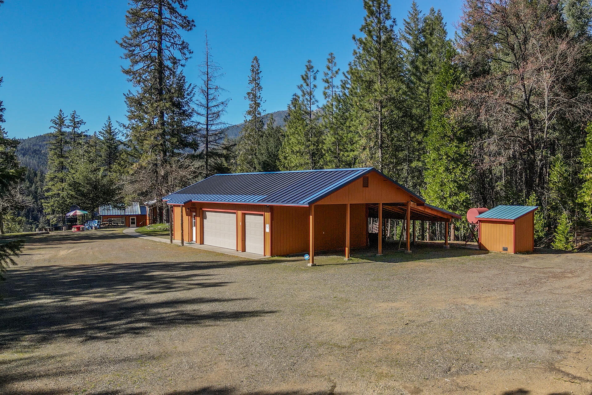 8341 East Side Road Trinity Center, CA 96091 - Photo 46 of 79 a front view of a house with a yard garage and outdoor seating