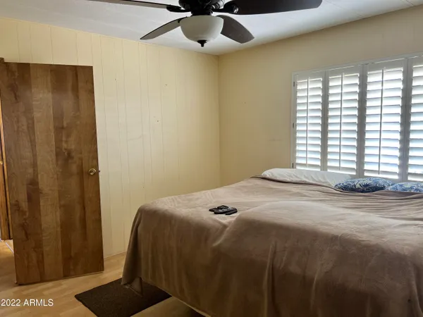 a bedroom with a bed and a chandelier