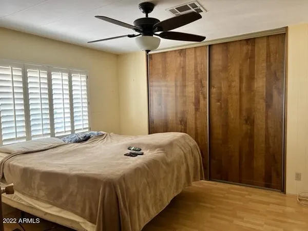 a bedroom with a bed and a window