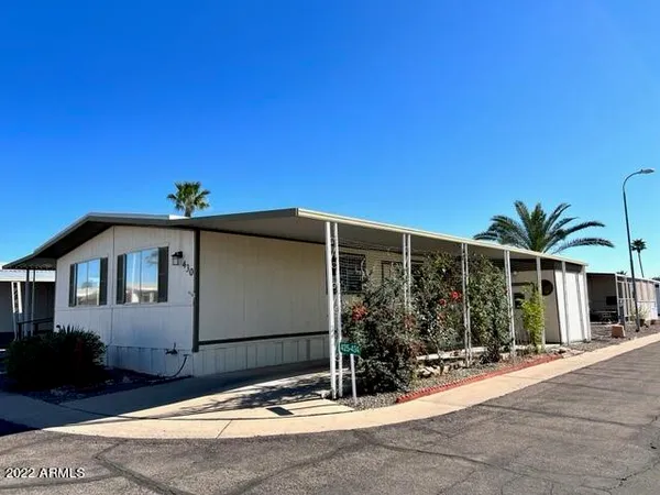 a front view of a house with glass windows and yard