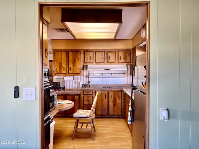 a view of a room with chairs and a window
