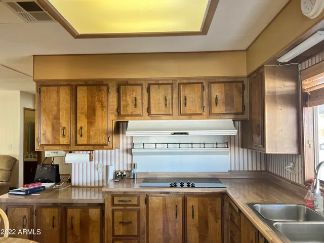 a kitchen with stove and cabinets