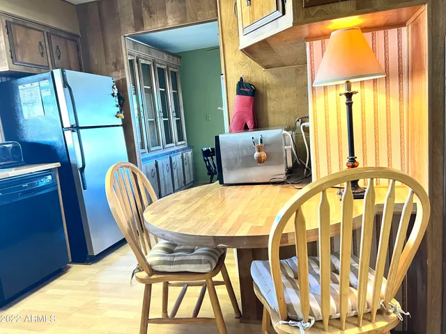 a view of a dining room with furniture and a window