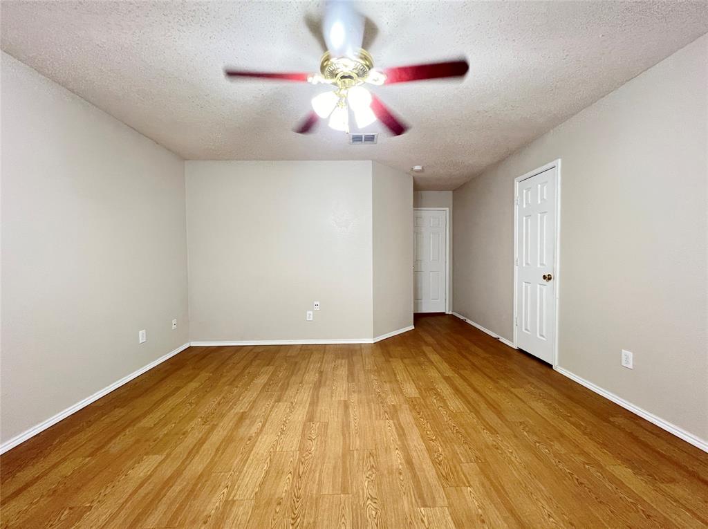 2217 Lookout Lane Denton, TX 76207 - Photo 15 of 18 a view of room with wooden floor and ceiling fan