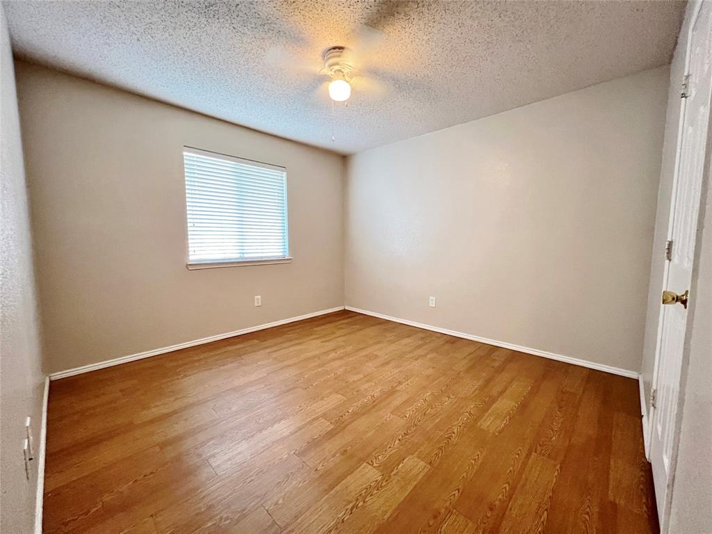 2217 Lookout Lane Denton, TX 76207 - Photo 9 of 18 an empty room with a window and a ceiling fan