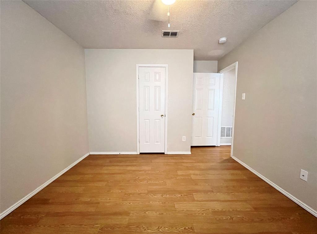 2217 Lookout Lane Denton, TX 76207 - Photo 10 of 18 a view of an empty room with wooden floor